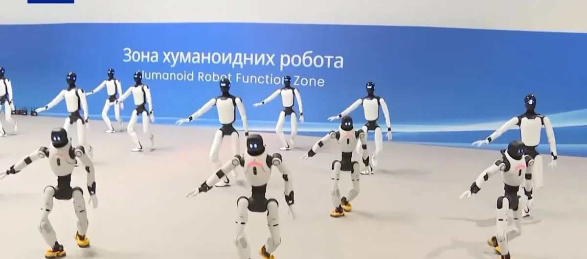 A dozen white-and-black humanoid robots stand in mid-stride on a pale floor in front of a blue banner reading "Humanoid Robot Function Zone" in Serbian and English.