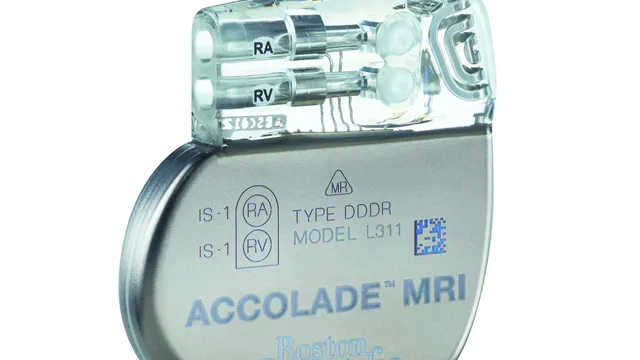 A titanium-cased dual-chamber pacemaker photographed against white, its clear epoxy header showing two lead ports marked RA and RV above the engraved device model text.