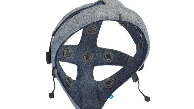 The underside of the Cumulus Neuroscience NeuLogiq dry-sensor EEG headset, showing its grey fabric headband and sixteen dark circular electrode contacts on a cross-shaped internal frame.