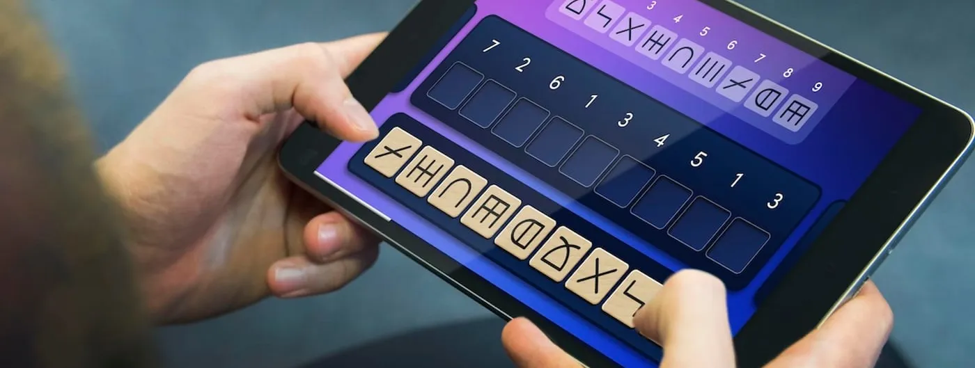 A pair of hands holds a small tablet showing a symbol-matching cognitive task, with rows of abstract glyph tiles and numbered slots on a purple-to-blue gradient screen.