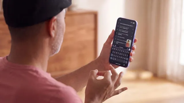Seen from behind, a man in a cap holds a phone in one hand and shapes a sign with the other while the screen fills with search suggestions.