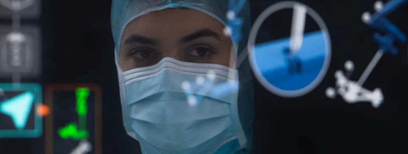 A surgeon in a blue surgical cap and mask looks toward the camera in a darkened operating theatre, with translucent navigation graphics and tracker markers overlaid across the foreground.