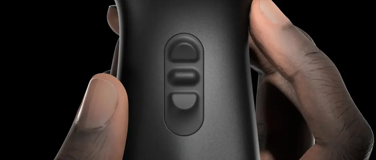 A hand holds a black handheld ultrasound probe against a dark background, its control buttons and the blue butterfly mark on the casing facing the camera.