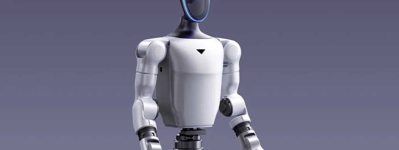 A white-and-black Unitree G1 humanoid robot standing upright, showing its helmet-style head with a glowing blue visor strip, articulated neck, torso, and shoulder and arm joints against a plain grey studio background.